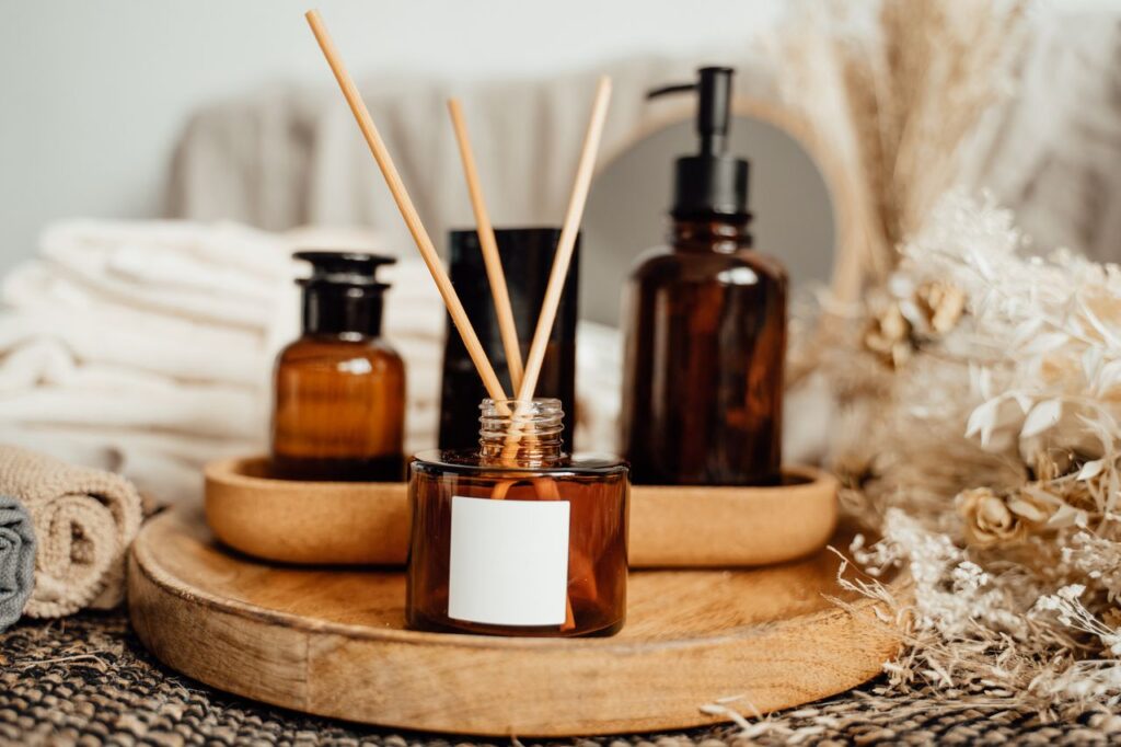 A soothing aromatherapy arrangement with amber bottles and dried flowers, perfect for a calming atmosphere.